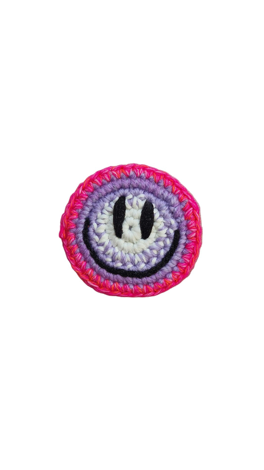 Hand-crochet acid house face badge hot pink halo gradient 90s rave pin Free Range Smilies Qravers London