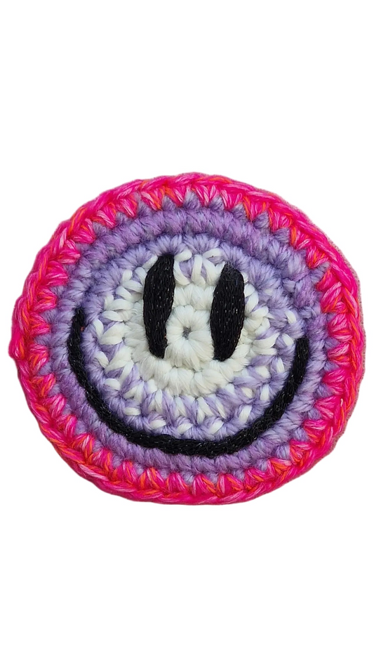 Hand-crochet acid house face badge hot pink halo gradient 90s rave pin Free Range Smilies Qravers London