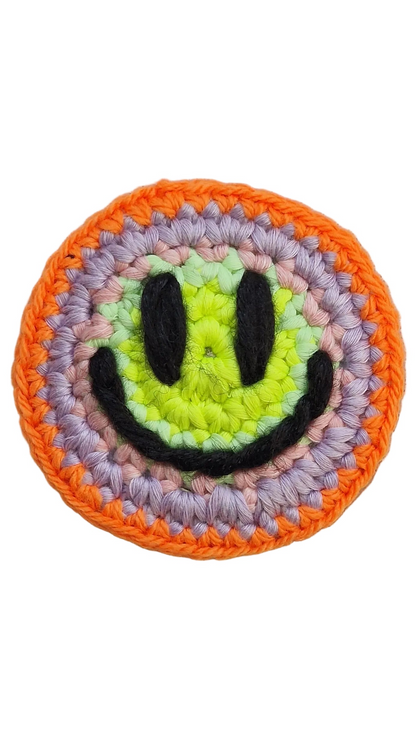 Hand-crochet acid house face badge sunset acid orange yellow gradient 90s rave pin Free Range Smilies Qravers London