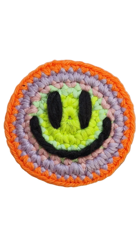 Hand-crochet acid house face badge sunset acid orange yellow gradient 90s rave pin Free Range Smilies Qravers London