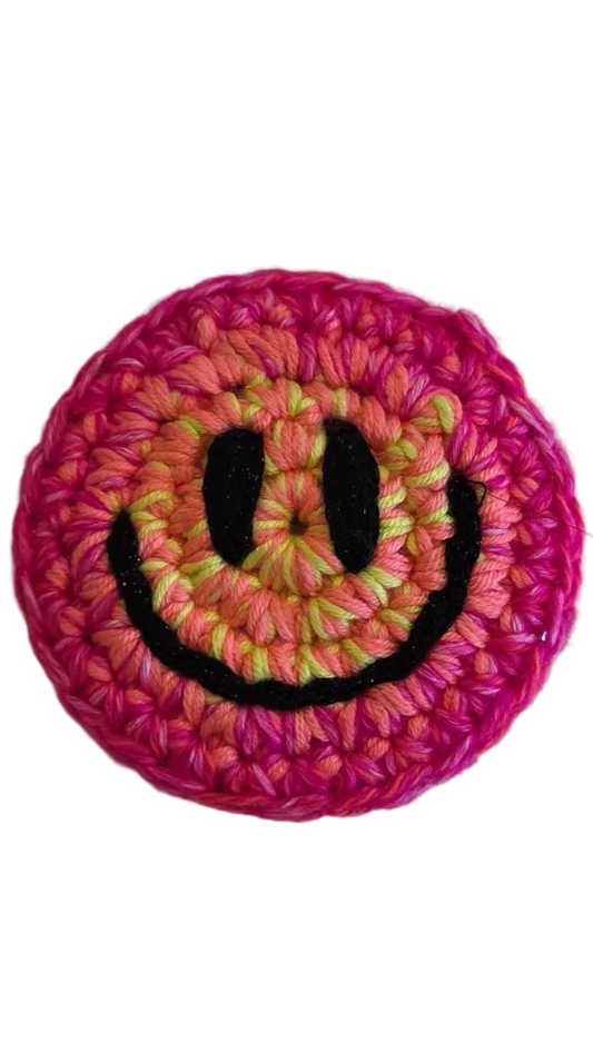 Hand-crochet acid house face badge hot pink halo gradient 90s rave pin Free Range Smilies Qravers London