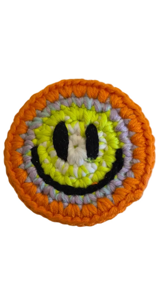 Hand-crochet acid house face badge sunset acid orange yellow gradient 90s rave pin Free Range Smilies Qravers London