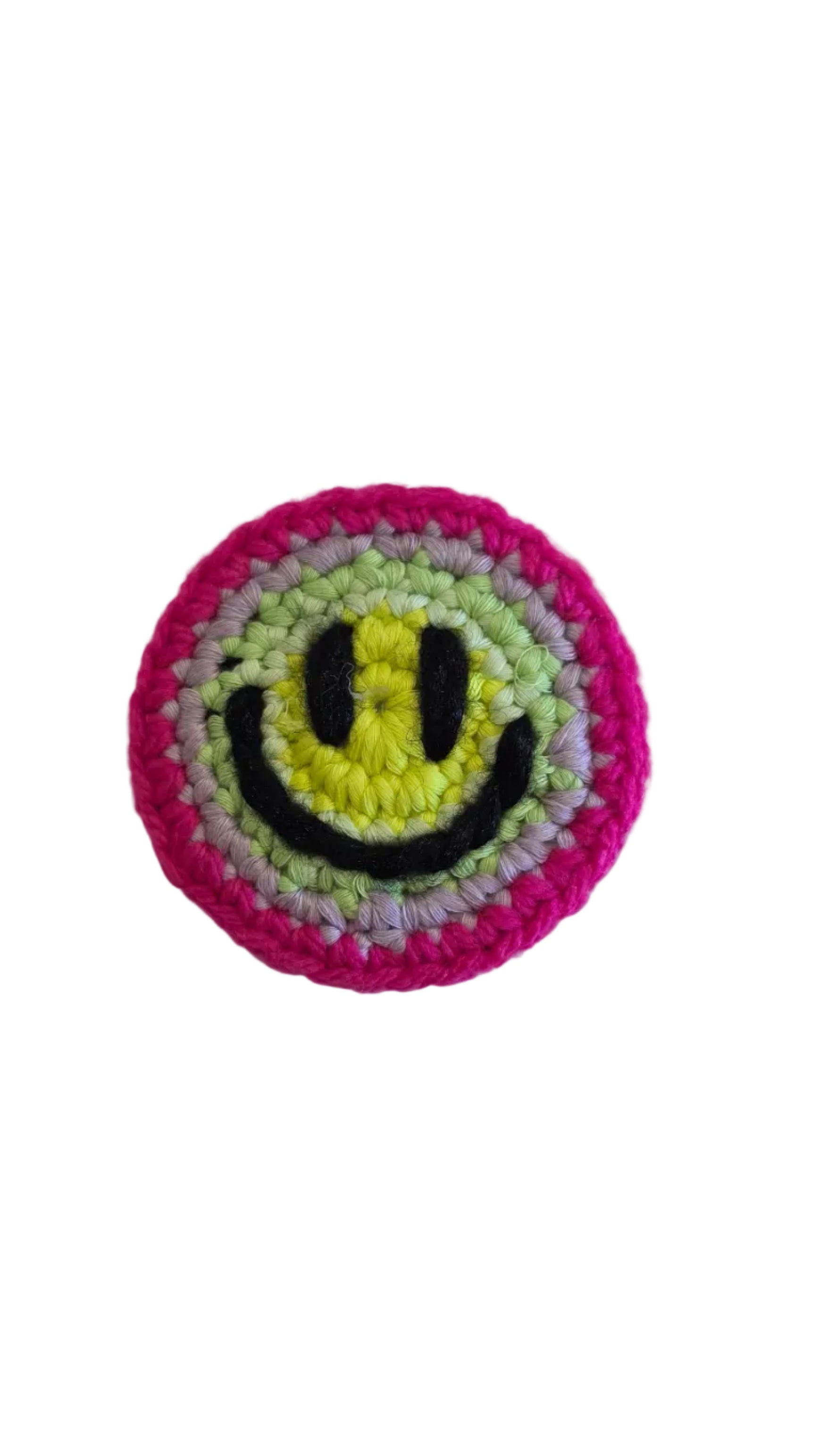 Crocheted patch with smiley face design on a white background